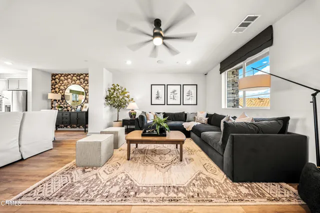 a living room with furniture and a large window