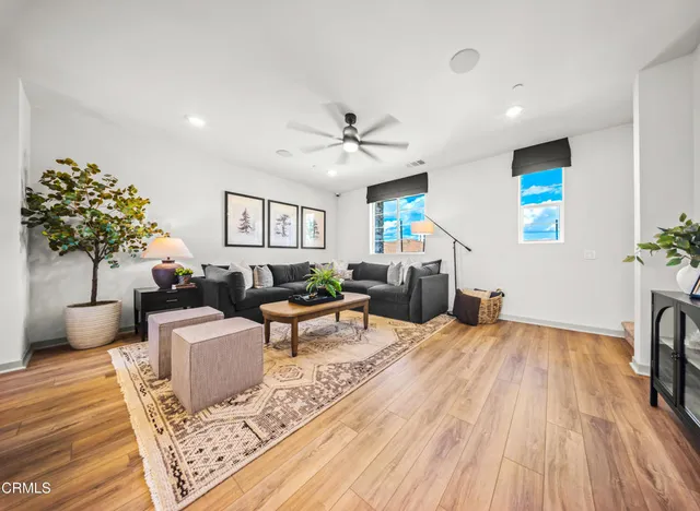 a living room with furniture a chandelier and a rug