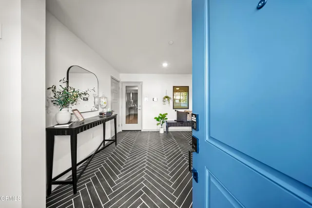 a view of a livingroom with furniture and a potted plant