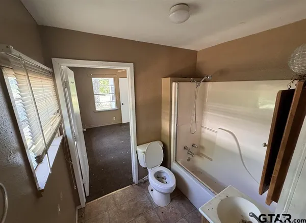 a bathroom with a toilet and a shower
