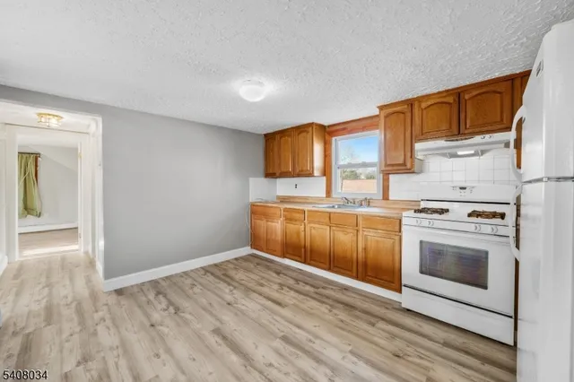 a kitchen with a stove top oven sink and cabinets