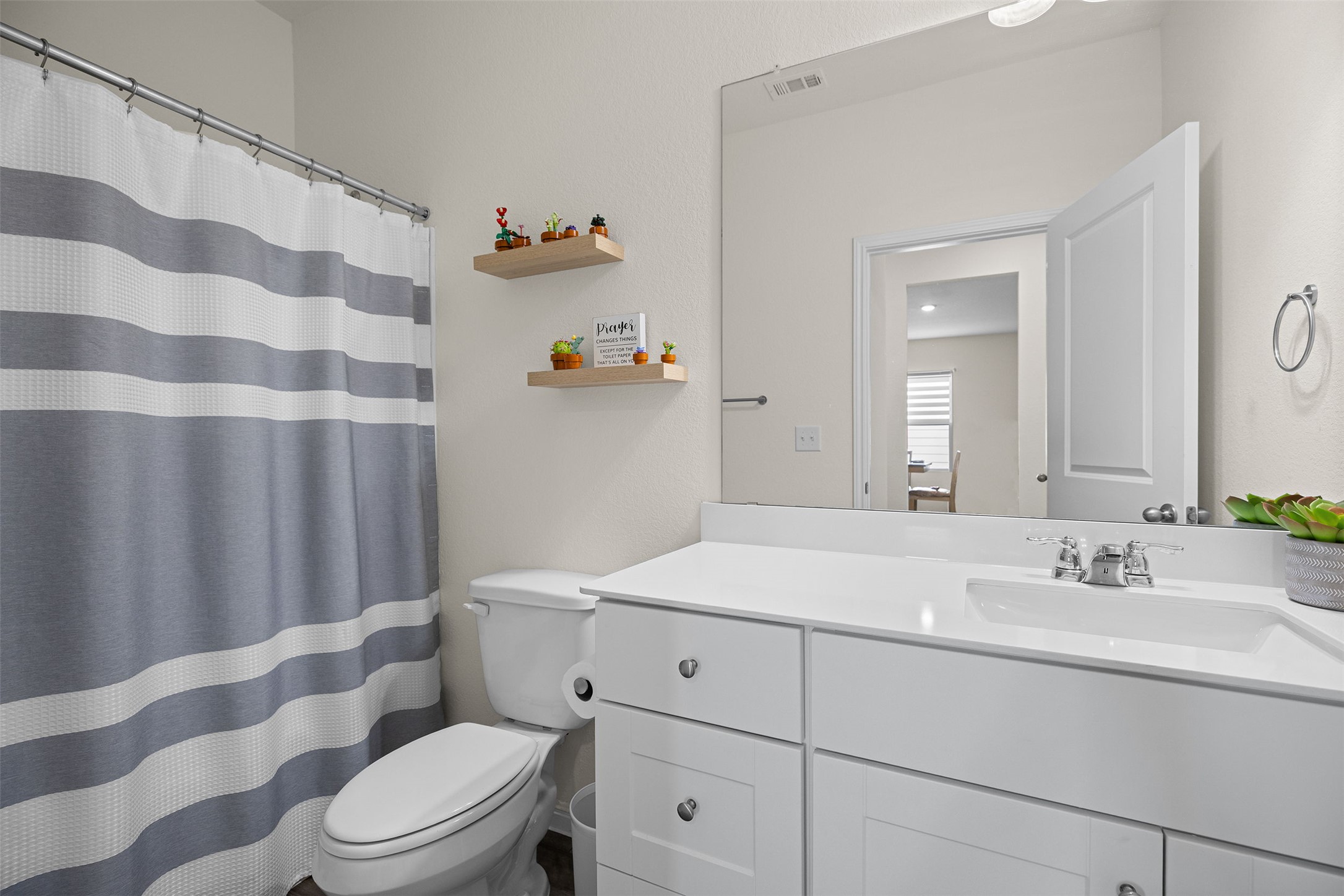 104 Enforcer Loop Jarrell, TX 76537 - Photo 10 of 12 a bathroom with a sink toilet and shower