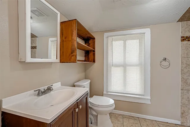 a bathroom with a sink toilet and vanity