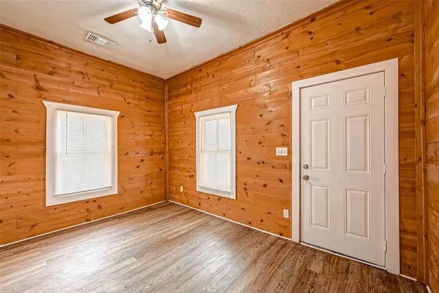 wooden floor in an empty room with a window