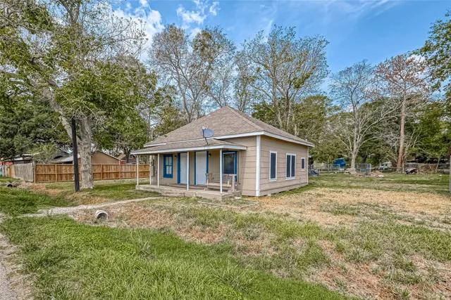 a front view of house with yard and trees