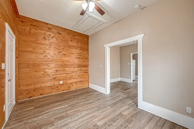 a view of an empty room with wooden floor