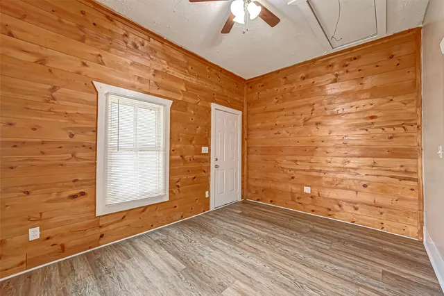 a view of empty room with wooden floor