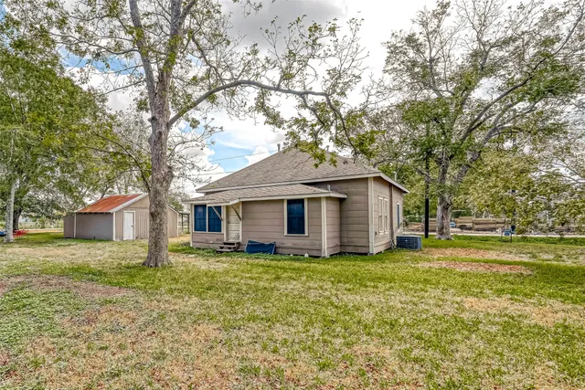 a white house that has a tree in front of it