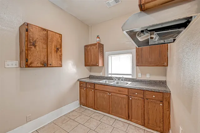 a kitchen with a sink and cabinets