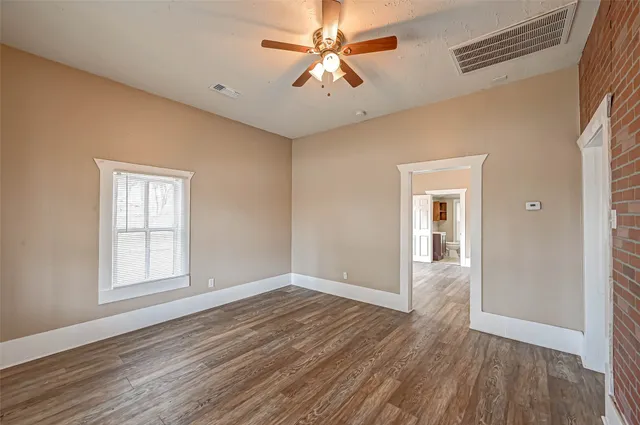 wooden floor in an empty room with a window