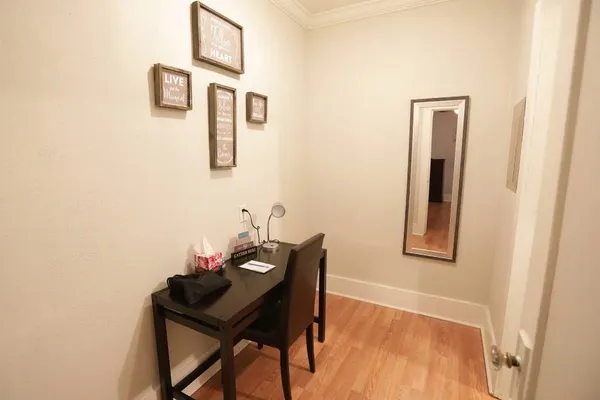 a view of a room that has a table and chair in it
