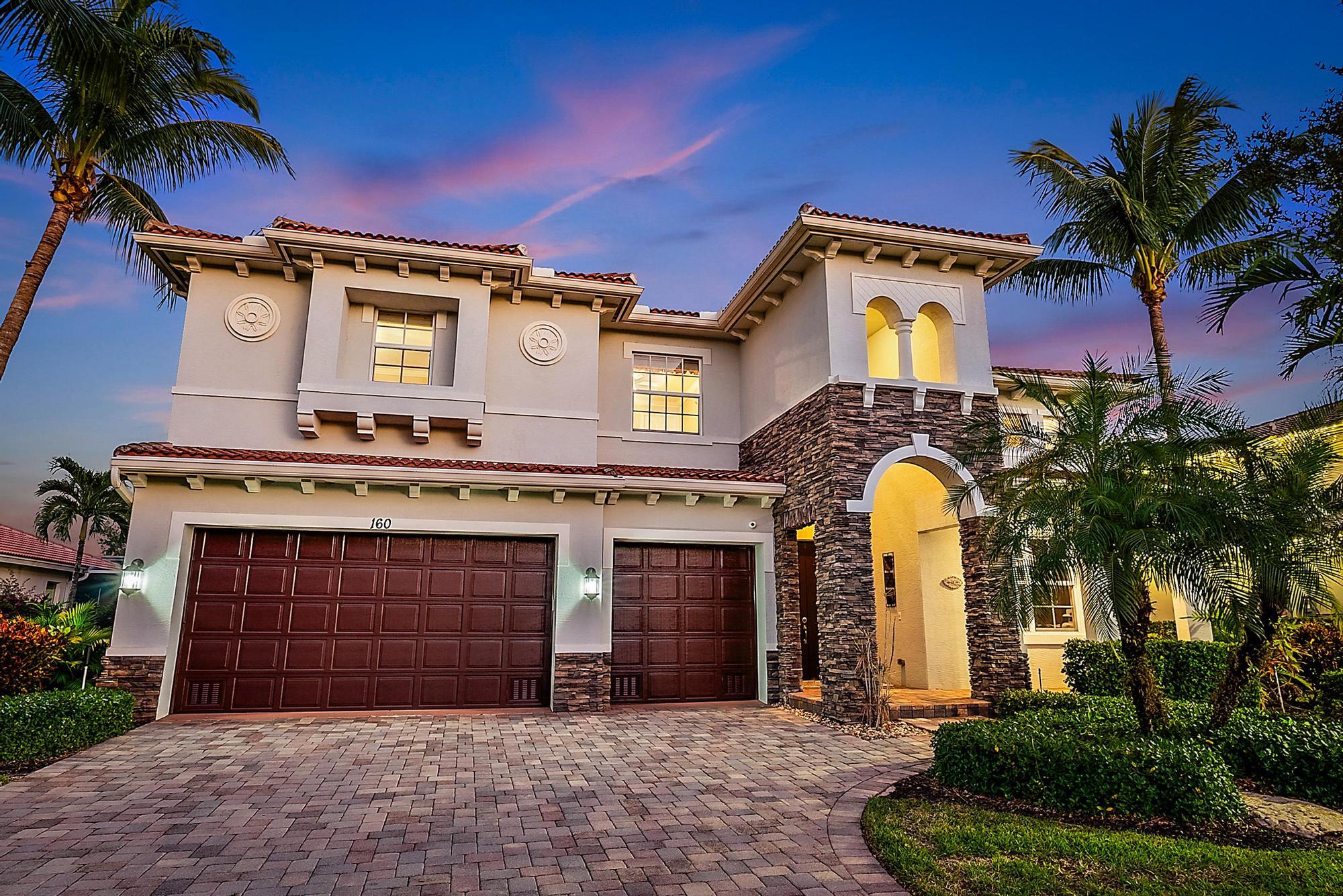160 Umbrella Place Jupiter, FL 33458 - Photo 10 of 24 a front view of a house with a yard