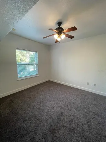 a bathroom with a granite countertop sink a toilet and bathtub