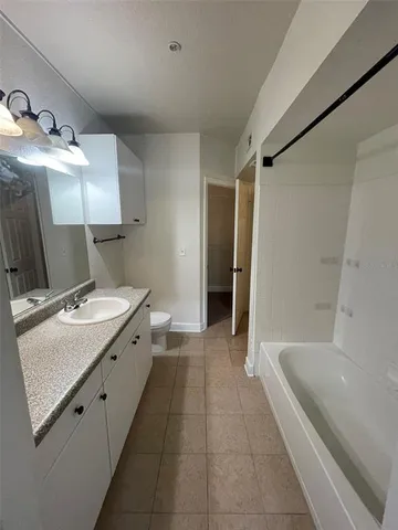 a bathroom with a granite countertop sink a mirror and a shower