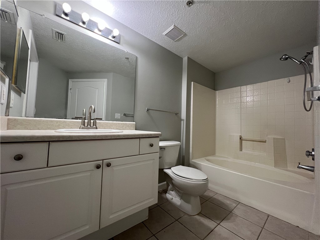 5090 Fairways Circle, Unit H308 Vero Beach, FL 32967 - Photo 12 of 19 a bathroom with a sink toilet and shower