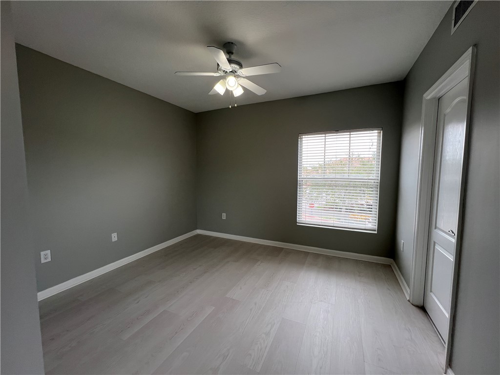5090 Fairways Circle, Unit H308 Vero Beach, FL 32967 - Photo 15 of 19 an empty room with wooden floor and windows