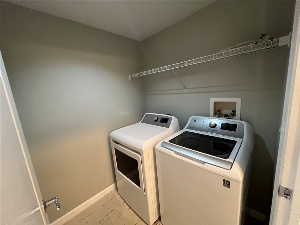 5090 Fairways Circle, Unit H308 Vero Beach, FL 32967 - Photo 19 of 19 a utility room with dryer and washer