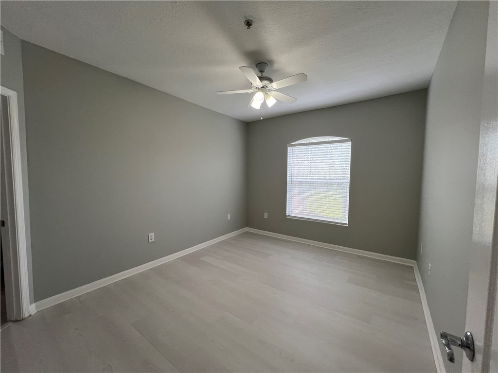 5090 Fairways Circle, Unit H308 Vero Beach, FL 32967 - Photo 8 of 19 an empty room with a window and a fan