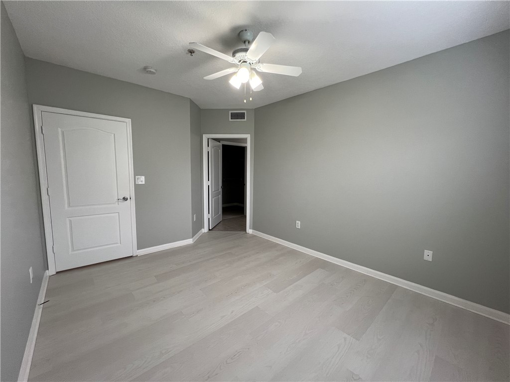 5090 Fairways Circle, Unit H308 Vero Beach, FL 32967 - Photo 9 of 19 an empty room with a chandelier fan and windows