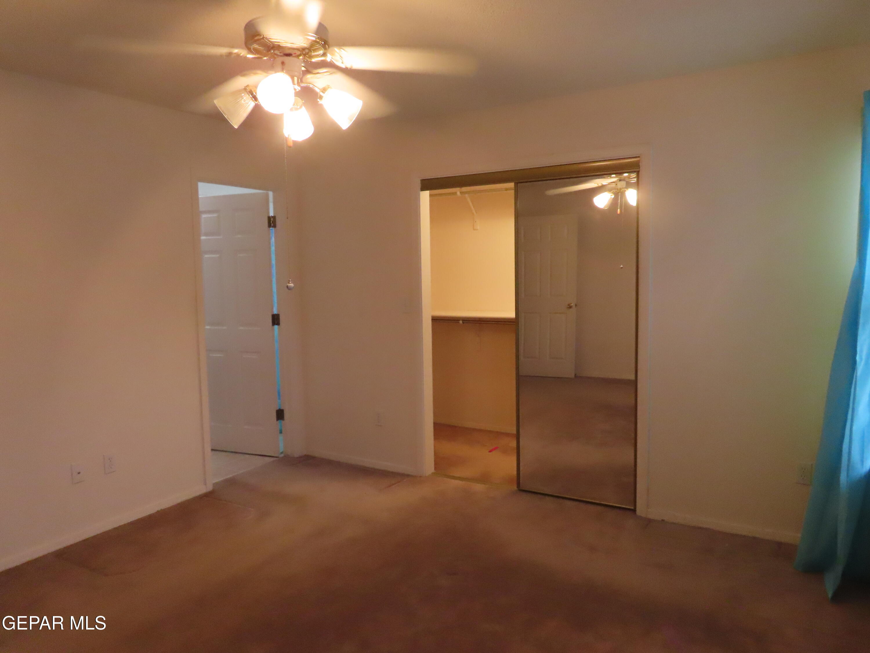 2210 Radford Street El Paso, TX 79903 - Photo 11 of 24 an empty room with closet and a chandelier fan