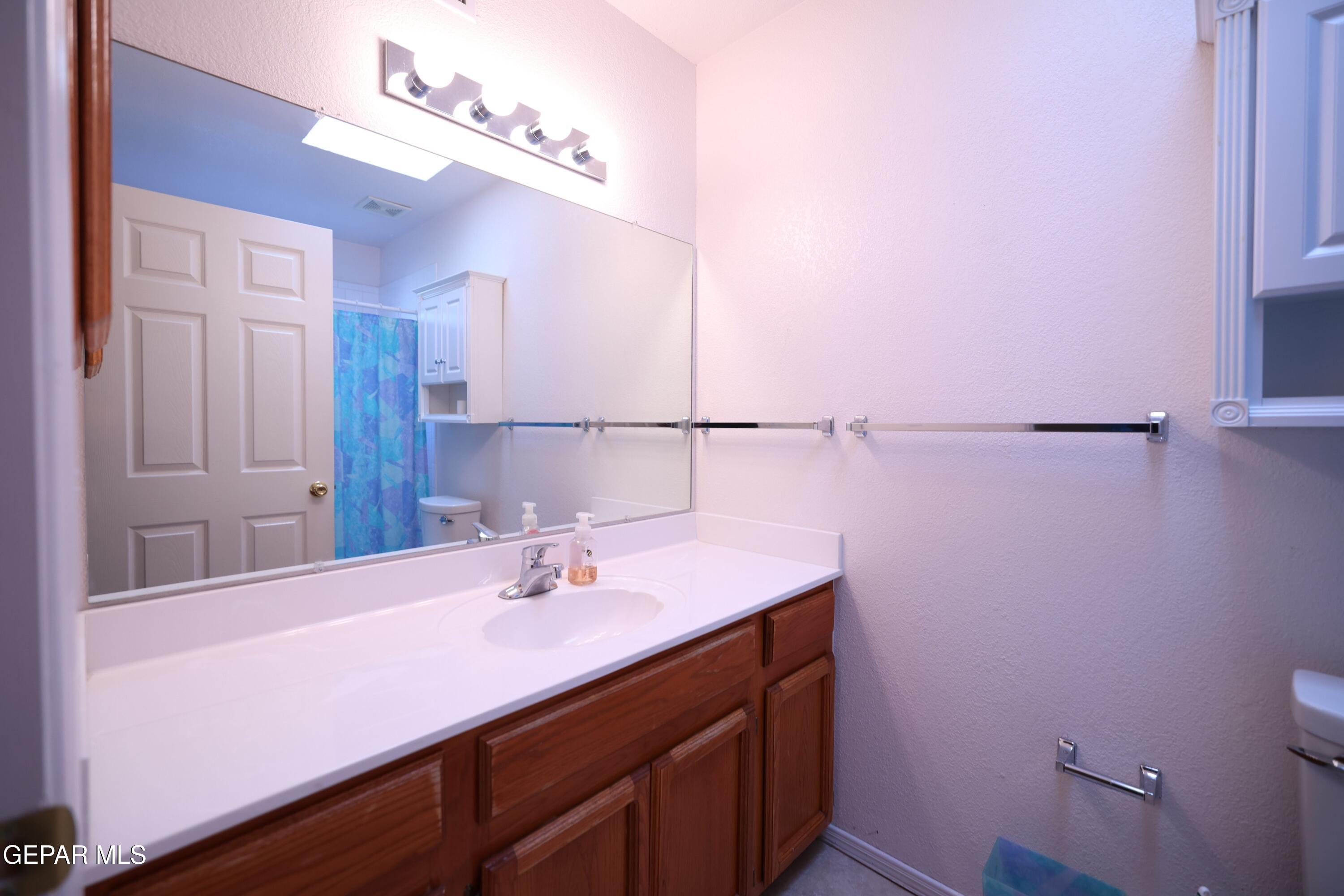 2210 Radford Street El Paso, TX 79903 - Photo 12 of 24 a bathroom with a sink vanity and a mirror