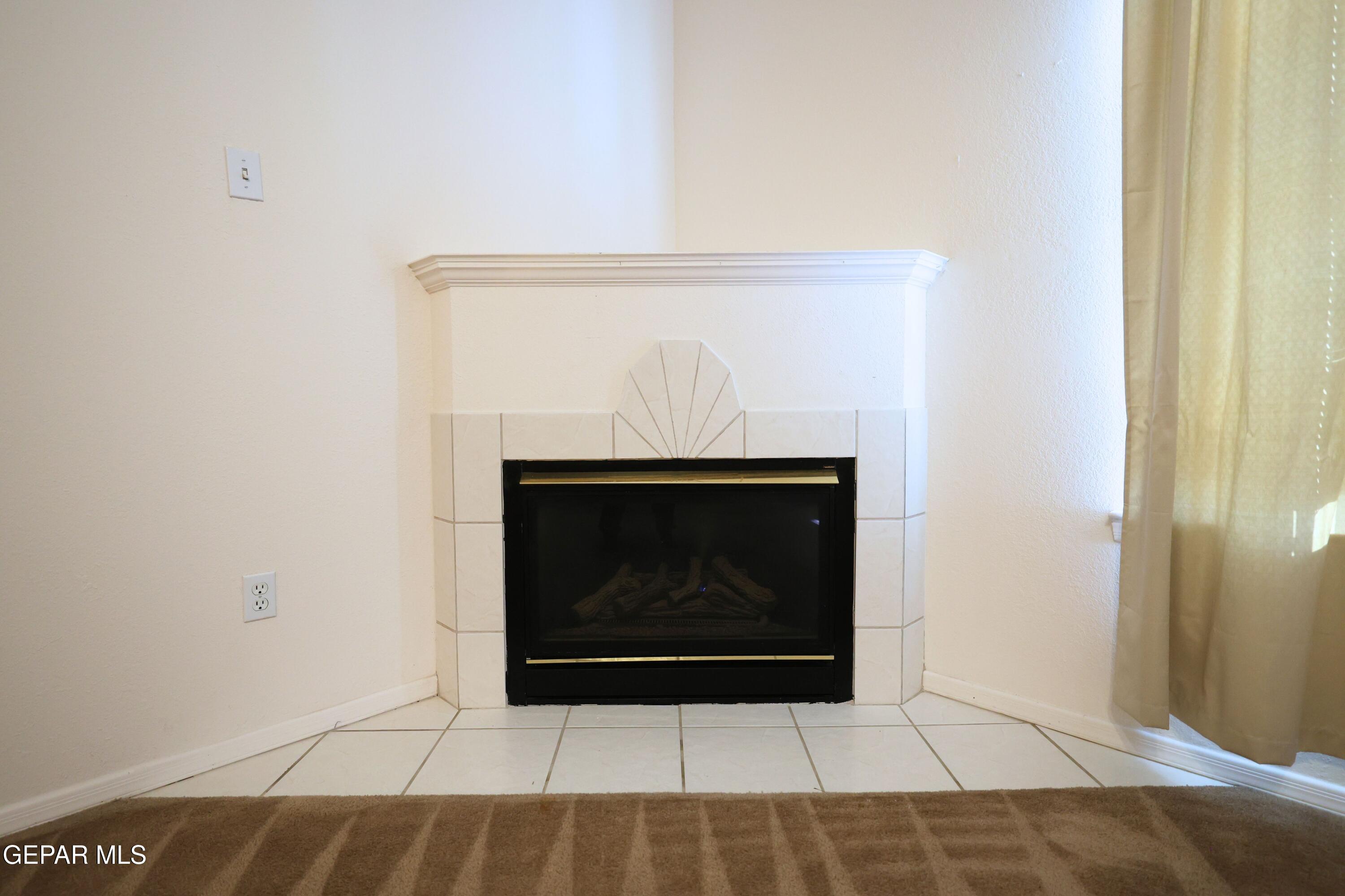 2210 Radford Street El Paso, TX 79903 - Photo 4 of 24 a fireplace with a clock on it