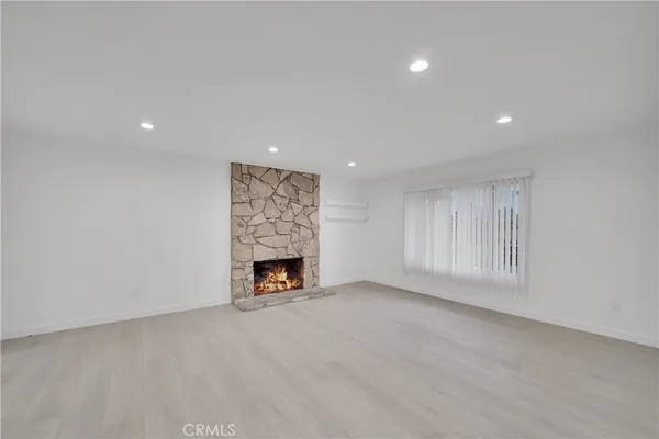 a view of an empty room with a fireplace