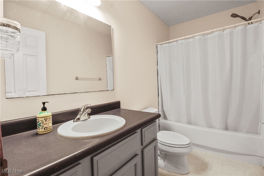 2632 Berry Road Akron, OH 44320 - Photo 26 of 39 Full bathroom featuring shower / bath combo, vanity, toilet, and tile patterned floors