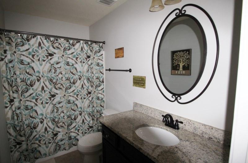 4556 Hermosa Road Crestview, FL 32539 - Photo 15 of 35 a bathroom with a granite countertop sink and a mirror