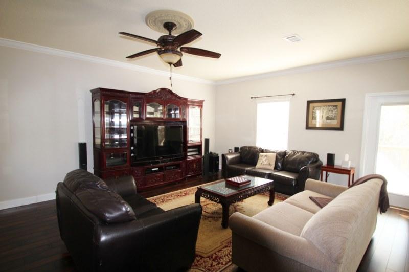 4556 Hermosa Road Crestview, FL 32539 - Photo 17 of 35 a living room with furniture a rug and a ceiling fan