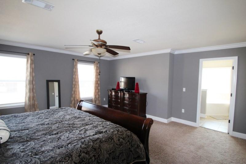 4556 Hermosa Road Crestview, FL 32539 - Photo 28 of 35 a bedroom with a bed and a chandelier