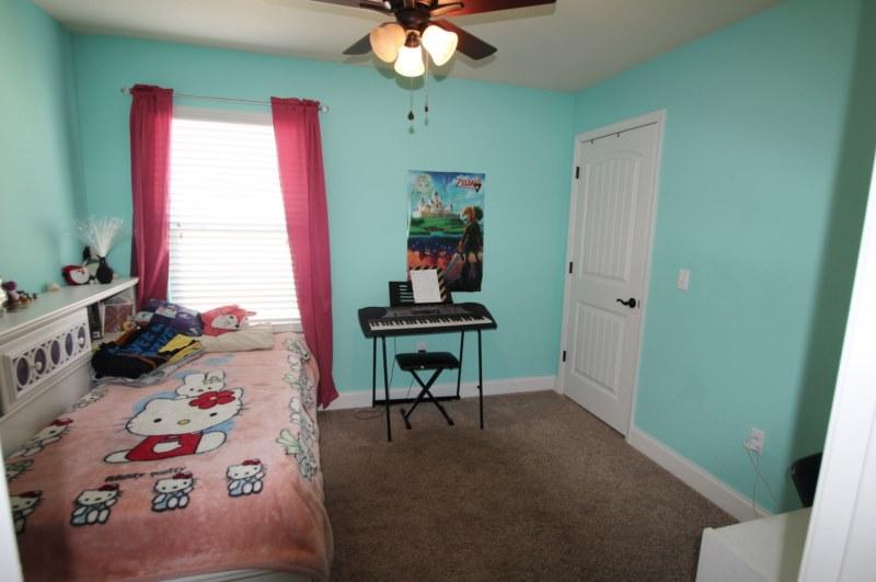 4556 Hermosa Road Crestview, FL 32539 - Photo 29 of 35 a bedroom with a bed and a chandelier