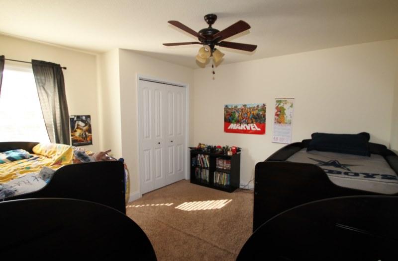 4556 Hermosa Road Crestview, FL 32539 - Photo 30 of 35 a bedroom with a bed and a chandelier