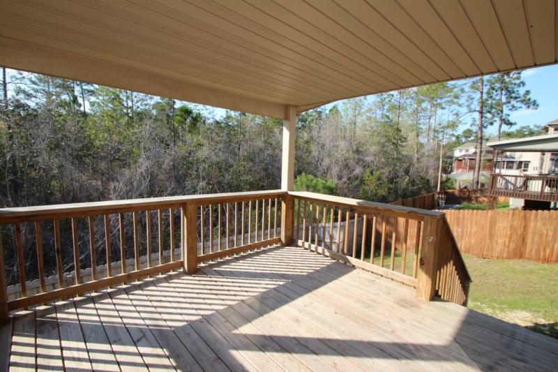 4556 Hermosa Road Crestview, FL 32539 - Photo 8 of 35 a view of balcony with wooden floor and outdoor seating