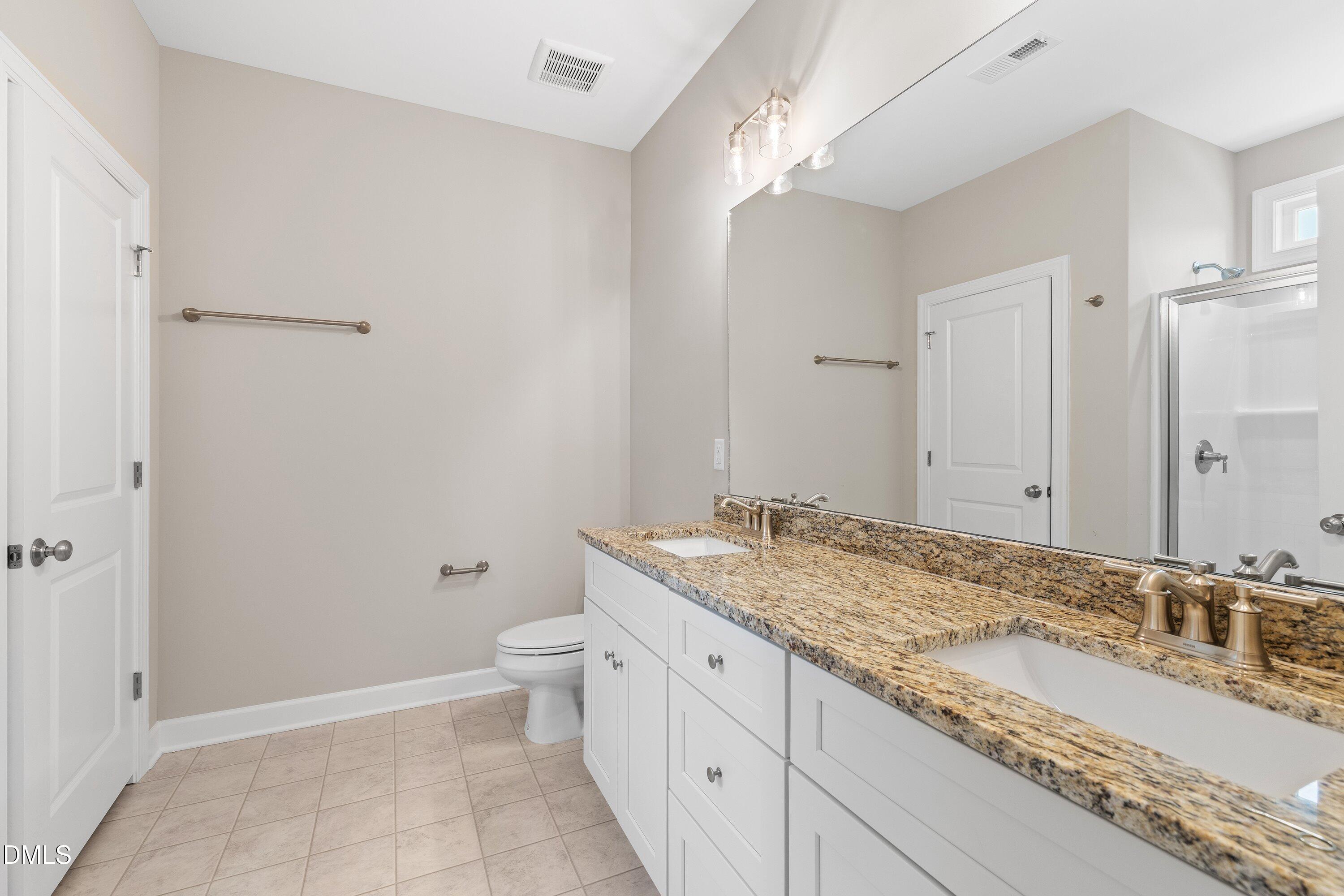 1115 Nor-Am Road Pikeville, NC 27863 - Photo 30 of 40 a bathroom with a granite countertop sink a toilet and shower