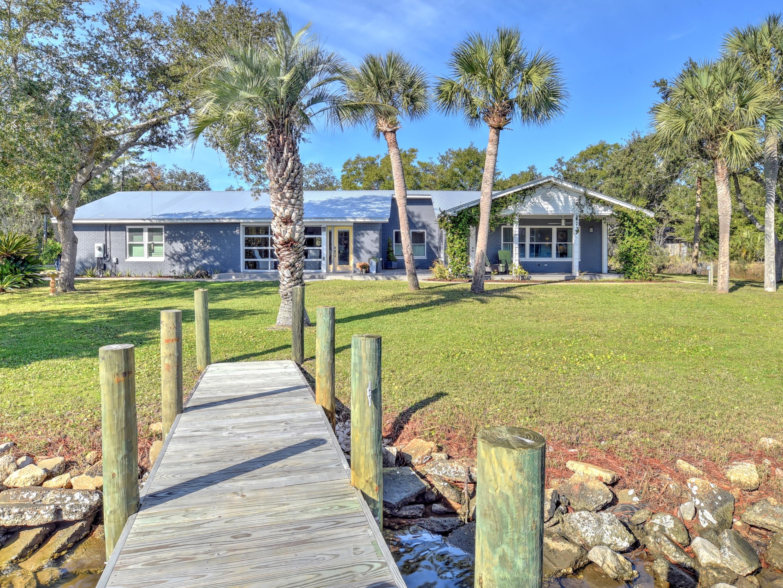 95 Bayou Road Santa Rosa Beach, FL 32459 - Photo 3 of 70 a front view of a house with a garden