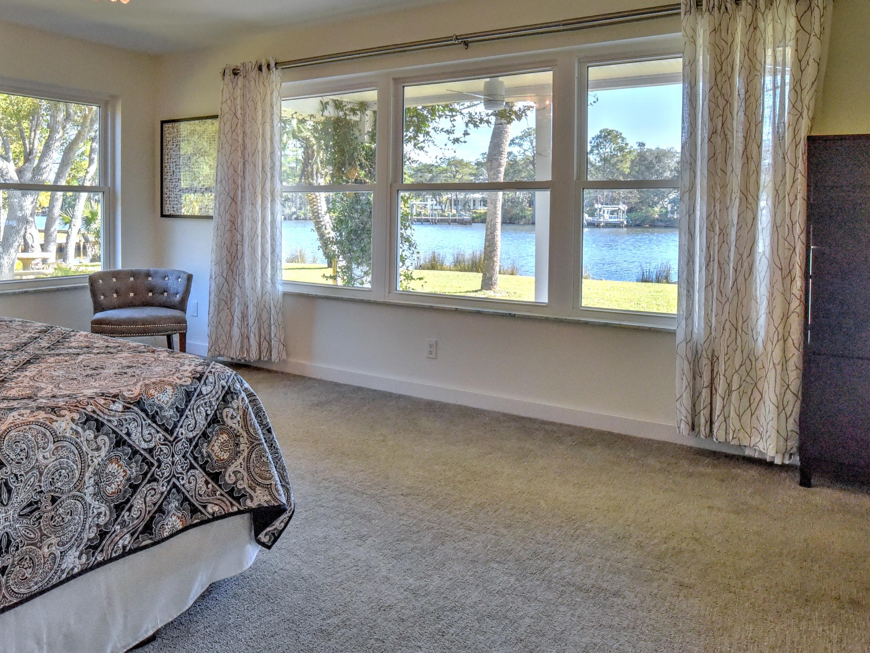 95 Bayou Road Santa Rosa Beach, FL 32459 - Photo 47 of 70 a bedroom with a bed and a large window with outer view