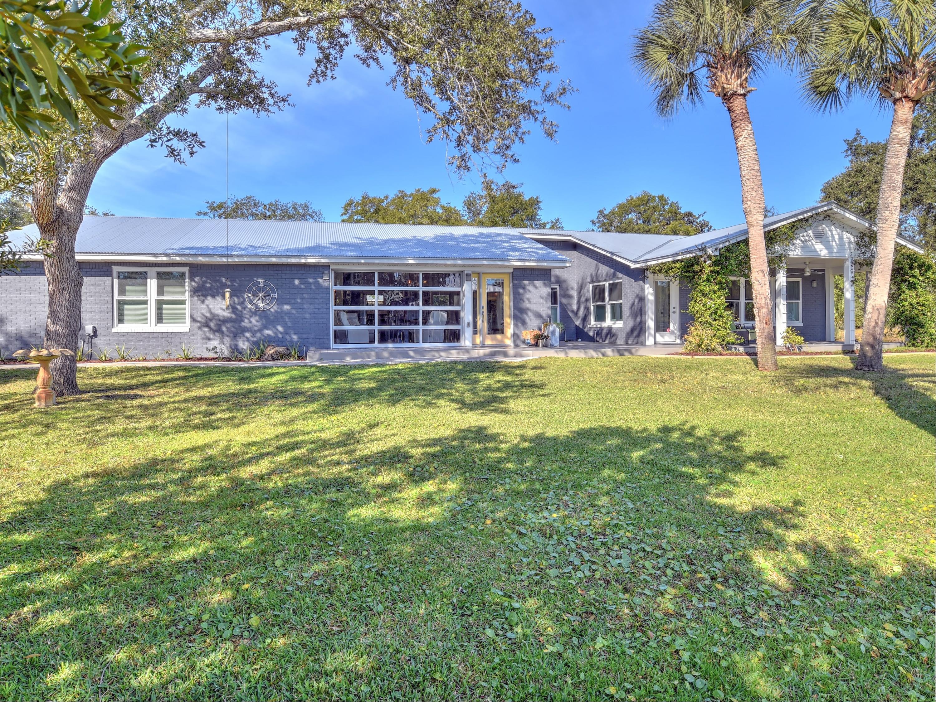 95 Bayou Road Santa Rosa Beach, FL 32459 - Photo 48 of 70 a large house with a big yard and palm trees