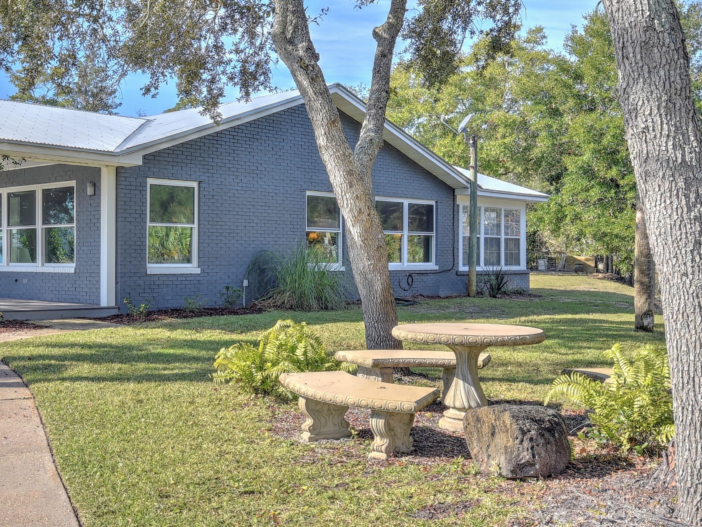 95 Bayou Road Santa Rosa Beach, FL 32459 - Photo 52 of 70 a view of a house with backyard and sitting area