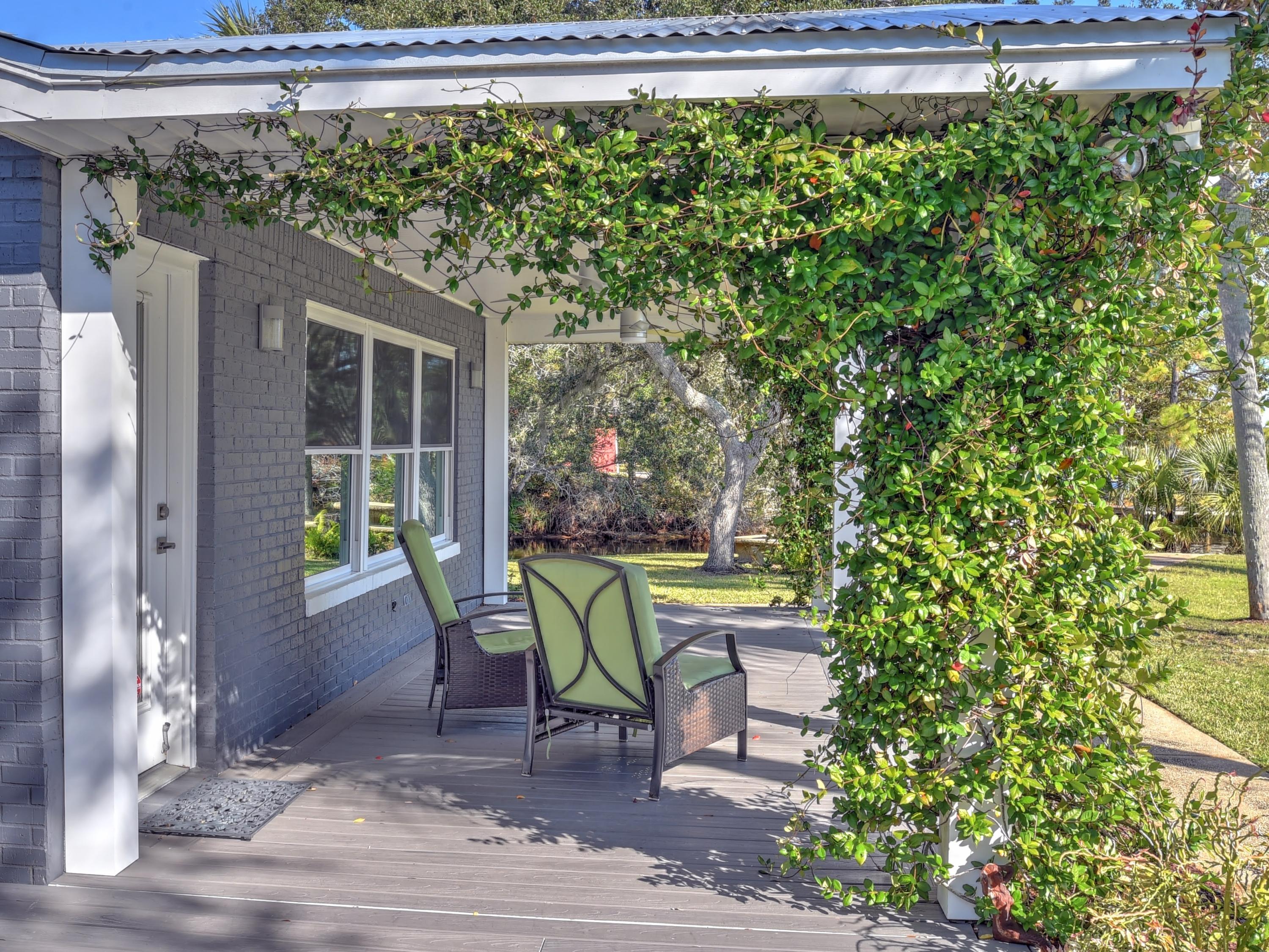 95 Bayou Road Santa Rosa Beach, FL 32459 - Photo 55 of 70 a view of a chair and table in the patio next to a yard