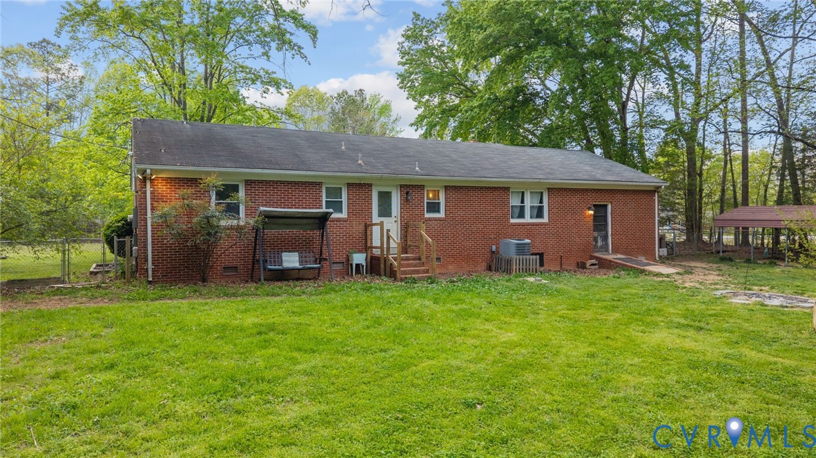 8141 Military Road Amelia Court House, VA 23002 - Photo 28 of 40 a backyard of a house with barbeque oven fire pit table and chairs