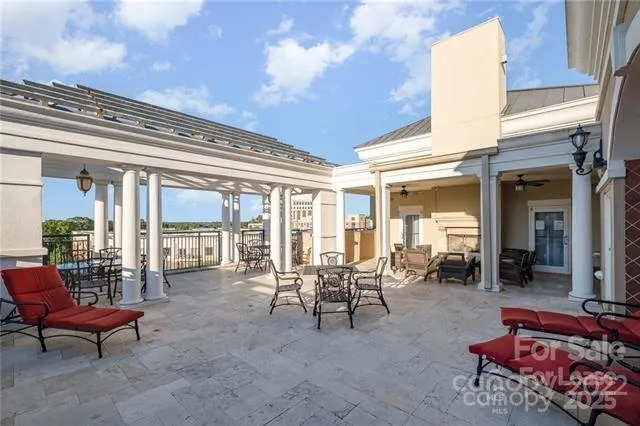 a building outdoor space with patio furniture and potted plants