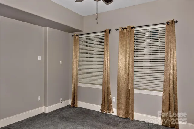 a view of a room with a window and a ceiling fan