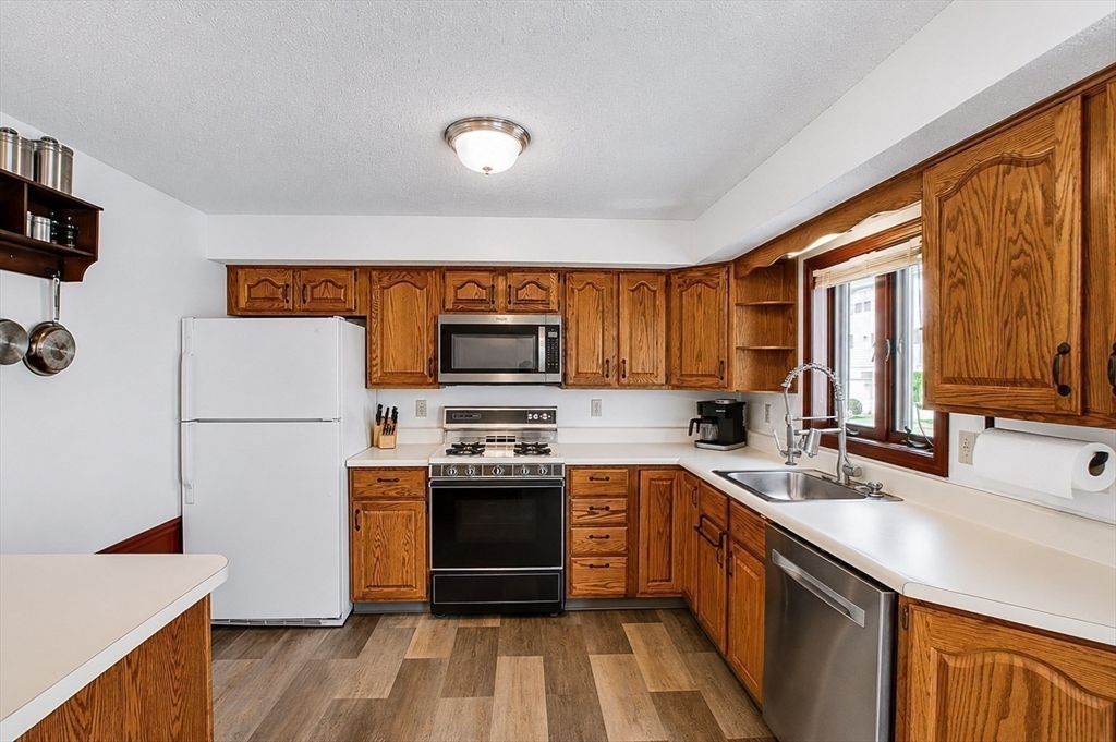 53 Century Way, Unit 53 Gardner, MA 01440 - Photo 10 of 22 a kitchen with stainless steel appliances a stove sink and refrigerator