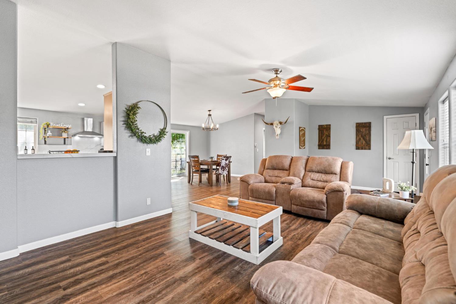 12518 Lone Oak Road Waterford, CA 95386 - Photo 11 of 50 a living room with furniture kitchen view and a chandelier