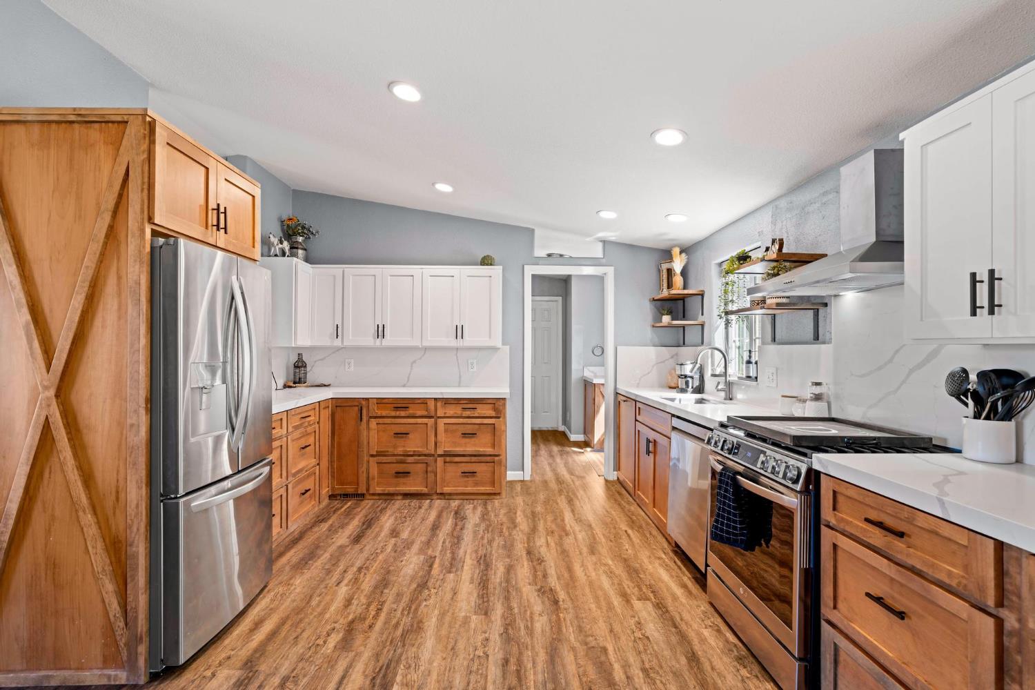 12518 Lone Oak Road Waterford, CA 95386 - Photo 13 of 50 a kitchen with stainless steel appliances a stove a refrigerator and a refrigerator