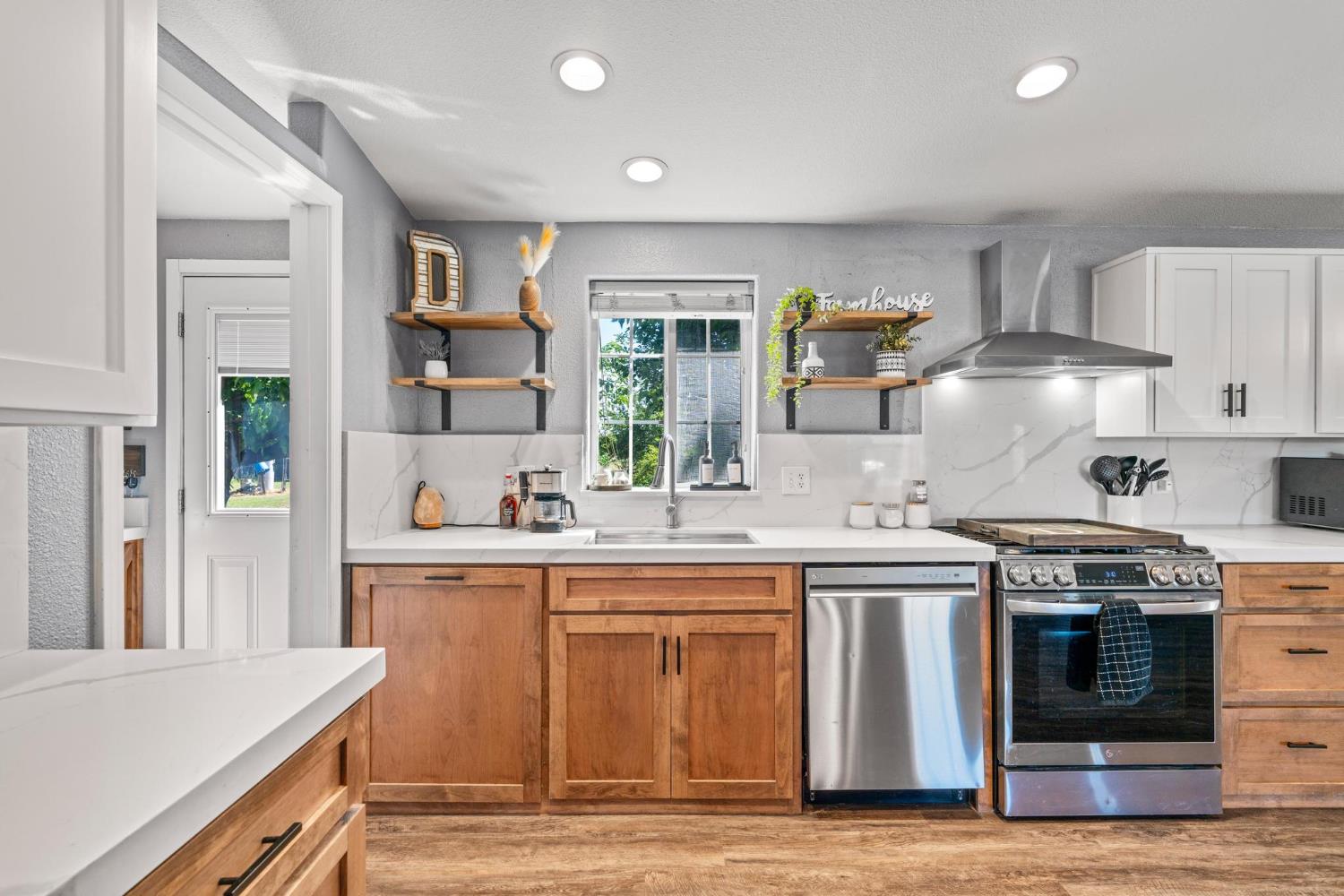 12518 Lone Oak Road Waterford, CA 95386 - Photo 14 of 50 a kitchen with stainless steel appliances granite countertop a stove and a sink