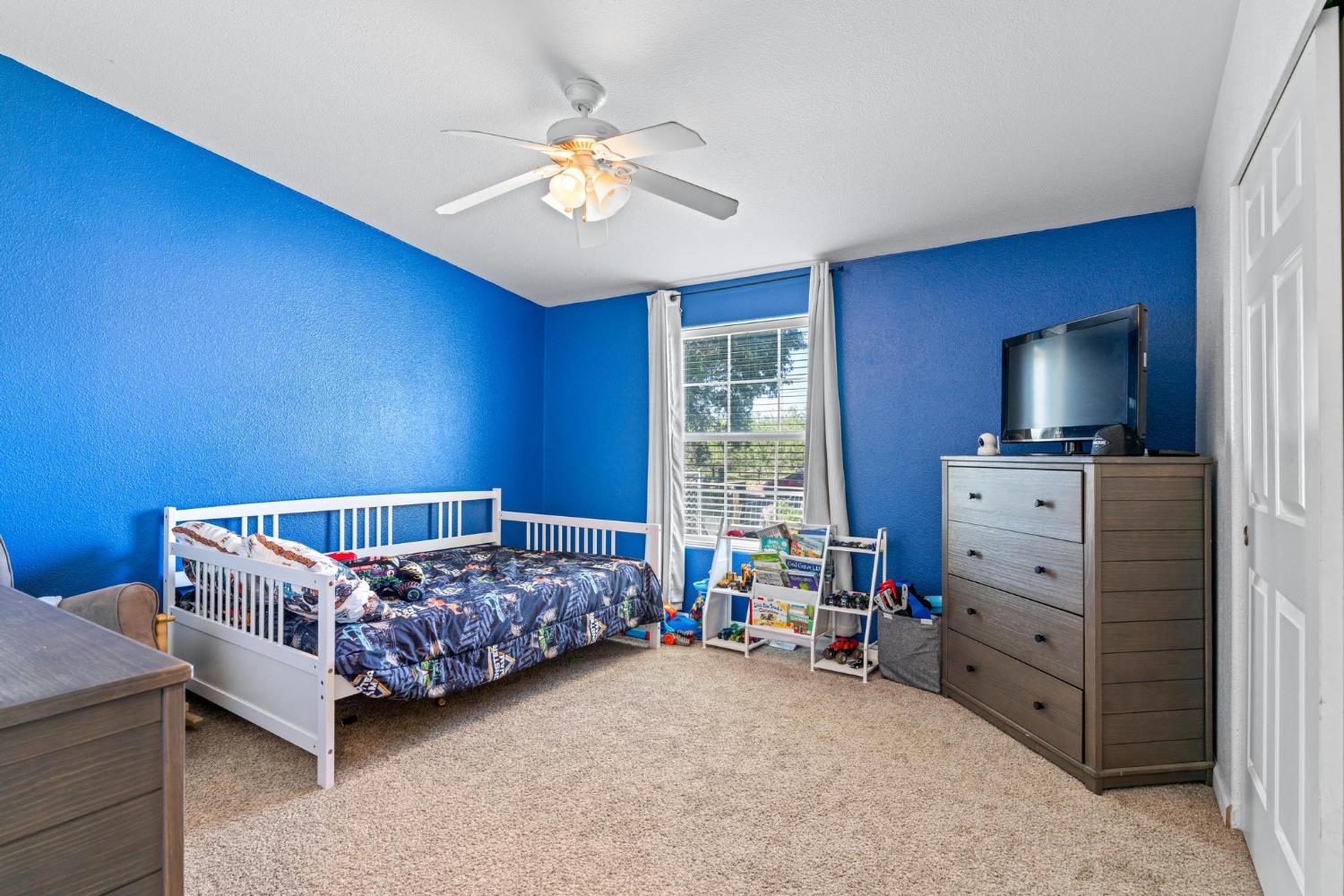 12518 Lone Oak Road Waterford, CA 95386 - Photo 24 of 50 a room with a baby bed couch and a window