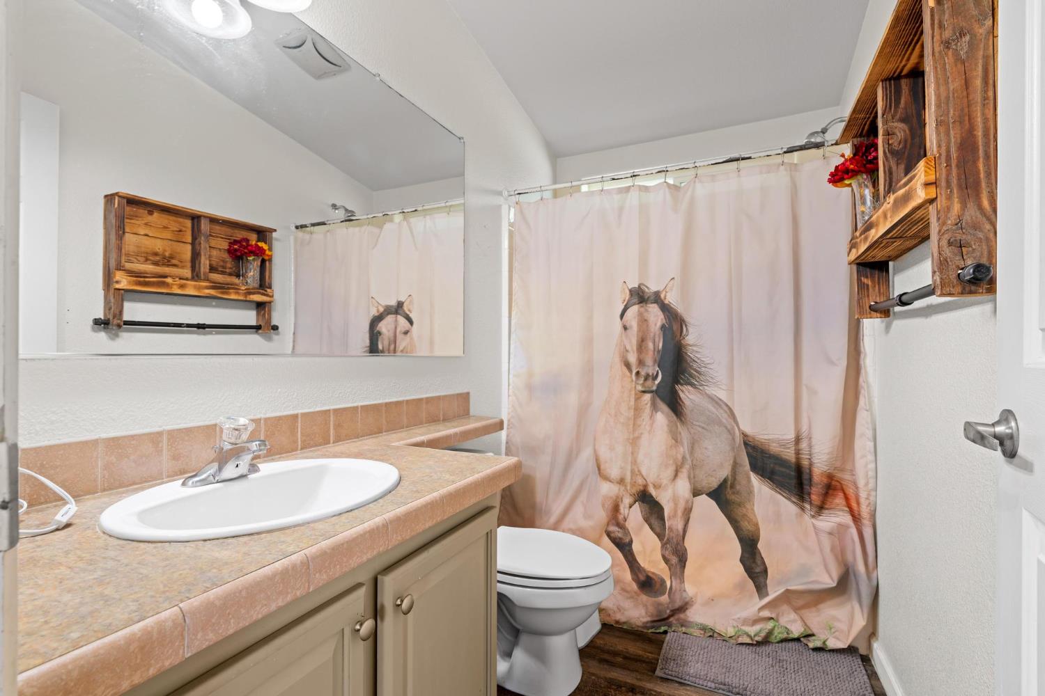 12518 Lone Oak Road Waterford, CA 95386 - Photo 25 of 50 a bathroom with a sink toilet and shower