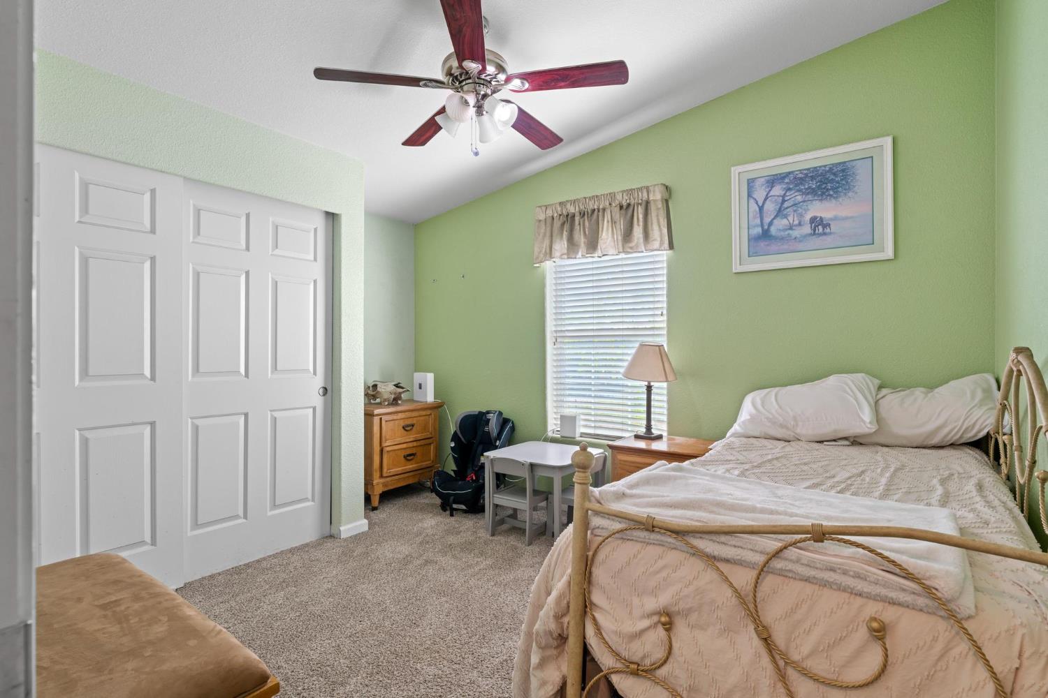 12518 Lone Oak Road Waterford, CA 95386 - Photo 26 of 50 a bedroom with a bed and a chandelier